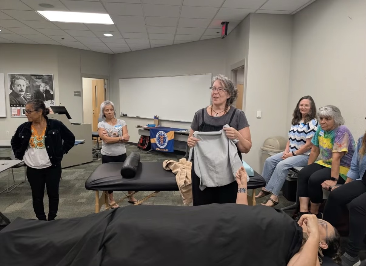 Amber Lester teaching a hands-on continuing education class for massage therapists